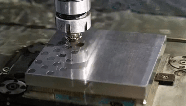 CNC milling operation on precision metal plate supported by rigid fixture for improved machining accuracy