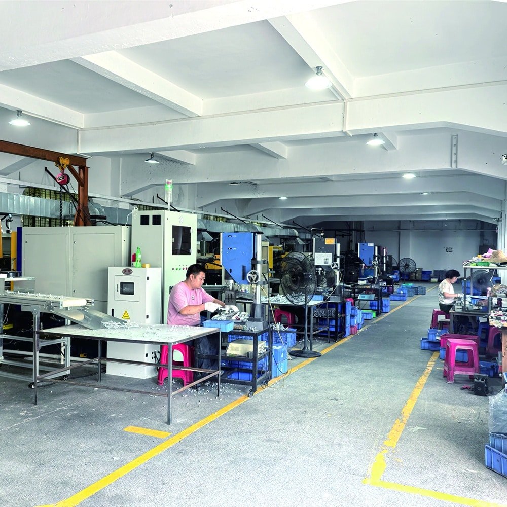 In-house die casting production workshop showing post-casting processing, trimming, and manual inspection of metal parts